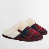 Tartan slippers with white fur lining on a light grey background